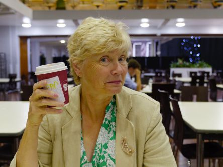 Karena grabs a coffee in the refectory.